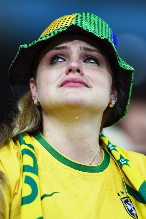 BELO HORIZONTE, BRAZIL - JULY 08:  An emotional Brazil fan reacts after being defeated by Germany 7-1 during the 2014 FIFA World Cup Brazil Semi Final match between Brazil and Germany at Estadio Mineirao on July 8, 2014 in Belo Horizonte, Brazil.  (Photo by Laurence Griffiths/Getty Images)