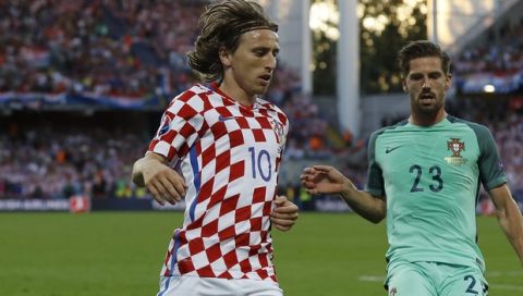 Croatia's Luka Modric, left, and Portugal's Adrien Silva during the Euro 2016 round of 16 soccer match between Croatia and Portugal at the Bollaert stadium in Lens, France, Saturday, June 25, 2016. (AP Photo/Frank Augstein)