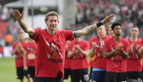 Leverkusen's forward Stefan Kiessling thanks supporters after the German Bundesliga soccer match between Bayer Leverkusen and Hannover 96 in Leverkusen, Germany, Saturday, May 12, 2018. Kiessling played for the club 12 years and ends his career after the match. (AP Photo/Martin Meissner)