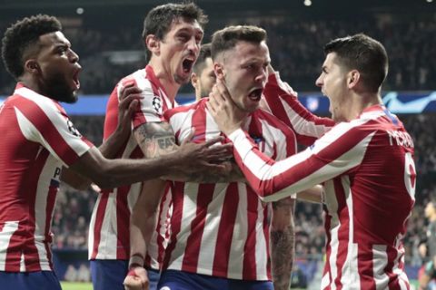 Atletico Madrid's Saul, second from right, celebrates after scoring his side's first goal during a first leg, round of 16, Champions League soccer match between Atletico Madrid and Liverpool at the Wanda Metropolitano stadium in Madrid, Spain, Tuesday Feb. 18, 2020. (AP Photo/Bernat Armangue)