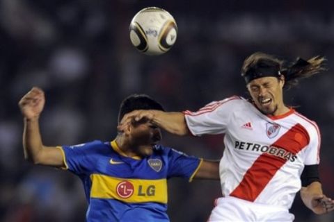 River Plate's Matias Jesus Almeyda, right, jumps for the ball with Boca Juniors' Lucas Viatri during their Argentine soccer league match in Buenos Aires, Argentina Tuesday Nov. 16, 2010. River Plate won 1-0. (AP Photo/Jorge Araujo)