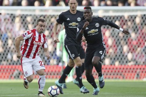 Stoke City's Xherdan Shaqiri and Manchester United's Paul Pogba, right, battle for the ball during the English Premier League soccer match at the bet365 Stadium, Stoke, England, Saturday, Sept. 9, 2017. (Nick Potts/PA via AP)