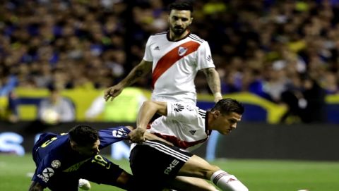 Mauro Karate of Boca Juniors, left, fights for the ball with Bruno Zuculini of River Plate during a local tournament soccer match in Buenos Aires, Argentina, Sunday, Sept. 23, 2018. (AP Photo/Natacha Pisarenko)