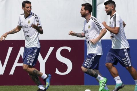 Angel Di Maria, left, talks to Lionel Messi, center, and Sergio Aguero during a training session of Argentina at the 2018 soccer World Cup in Bronnitsy, Russia, Thursday, June 28, 2018. (AP Photo/Ricardo Mazalan)