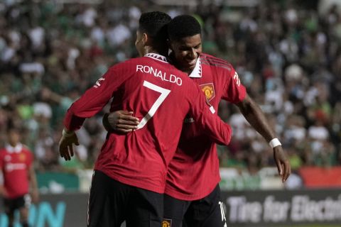 Manchester United's Marcus Rashford, right, celebrates with Cristiano Ronaldo after scoring his side's third goal during the Europa League group E soccer match between Omonia and Manchester United at GSP stadium in Nicosia, Cyprus, Thursday, Oct. 6, 2022. (AP Photo/Petros Karadjias)
