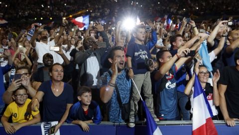 Supporters cheer French soccer players as they celebrate with the World Cup trophy during a ceremony following the UEFA Nations League soccer match between France and The Netherlands at the Stade de France stadium in Saint-Denis, outside Paris, France, Sunday, Sept. 9, 2018. (AP Photo/Christophe Ena)