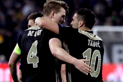 Ajax's Matthijs de Ligt, left, celebrates with his teammate Dusan Tadic after scoring his side's second goal during the Champions League, quarterfinal, second leg soccer match between Juventus and Ajax, at the Allianz stadium in Turin, Italy, Tuesday, April 16, 2019. (AP Photo/Luca Bruno)