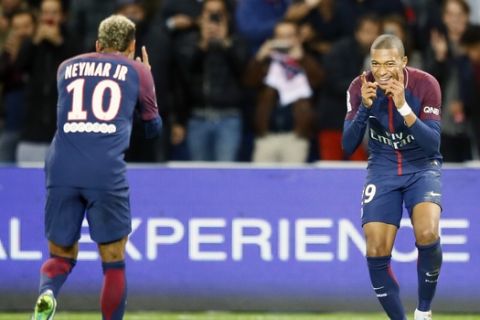 Paris Saint Germain's Kylian Mbappe, right, reacts with Neymar after he scored the second goal against Lyon during their French League One soccer match between PSG and Olympique Lyon at the Parc des Princes stadium in Paris, France, Sunday, Sept. 17, 2016. (AP Photo/Francois Mori)