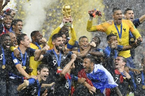 FILE - In this Sunday, July 15, 2018 file photo, France goalkeeper Hugo Lloris lifts the trophy after France won 4-2 during the final match between France and Croatia at the 2018 soccer World Cup in the Luzhniki Stadium in Moscow, Russia. World Cup winner France reclaims the No. 1 spot in the FIFA rankings for the first time in 16 years after defeating Croatia 4-2 for its second World Cup title and jumped up six places. (AP Photo/Martin Meissner, File)