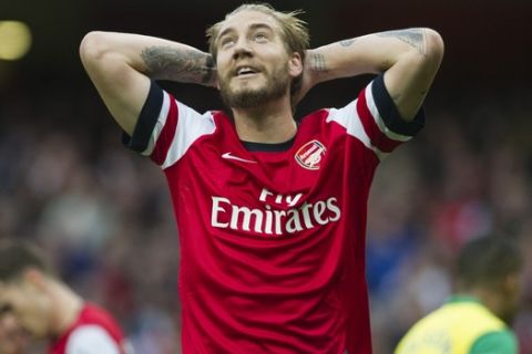 Arsenal's Nicklas Bendtner reacts after failing to score against Norwich City during their English Premier League soccer match, at the Emirates Stadium, in London, Saturday, Oct. 19, 2013. (AP Photo/Bogdan Maran)