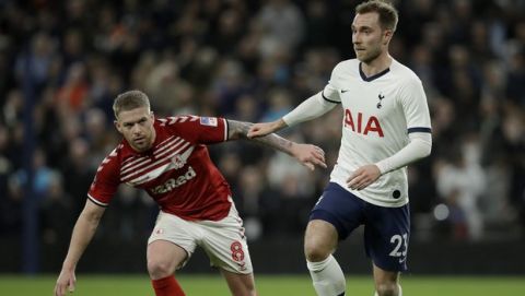 Middlesbrough's Adam Clayton, left, and Tottenham's Christian Eriksen challenge for the ball during the English FA Cup third round replay soccer match between Tottenham Hotspur and Middlesbrough FC at the Tottenham Hotspur Stadium in London, Tuesday, Jan. 14, 2020.(AP Photo/Matt Dunham)