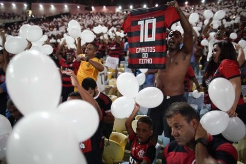 Fans pay homage to the 10 teenaged players who were killed by a fire at the Flamengo training center last Friday, at Maracana Stadium in Rio de Janeiro, Brazil, Thursday, Feb. 14, 2019, ahead of a soccer match between Flamengo and Fluminense. (AP Photo/Leo Correa)