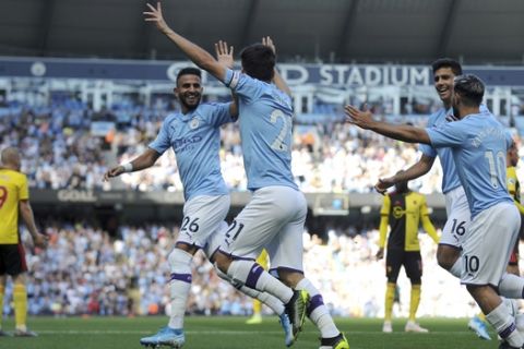 Manchester City's David Silva, center, celebrates with teammates after scoring his sides first goal during the English Premier League soccer match between Manchester City and Watford at Etihad stadium in Manchester, England, Saturday, Sept. 21, 2019. (AP Photo/Rui Vieira)
