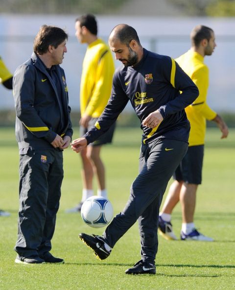 Spain's FC Barcelona head coach Josep Guardiola (R) plays with a ball during their training session in Yoikohama, suburban Tokyo, on December 12, 2011.  FC Barcelona will play against Asian champion Qatar's Al-Ssad at the semi-final of the FIFA Club World Cup here on December 14.    AFP PHOTO/Toru YAMANAKA (Photo credit should read TORU YAMANAKA/AFP/Getty Images)