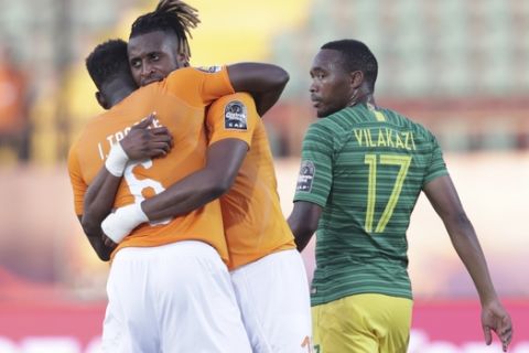 Ivory Coast players celebrate after the African Cup of Nations group D soccer match between Ivory Coast and South Africa in Al Salam Stadium in Cairo, Egypt, Monday, June 24, 2019. (AP Photo/Hassan Ammar)