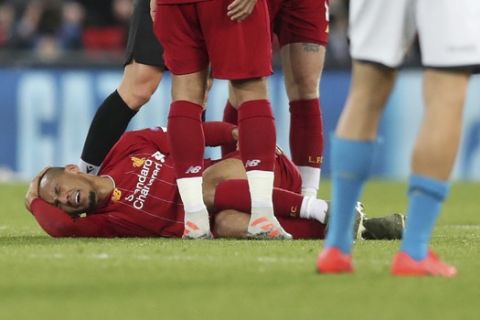 Liverpool's Fabinho lies injured before leaving the game during the Champions League Group E soccer match between Liverpool and Napoli at Anfield stadium in Liverpool, England, Wednesday, Nov. 27, 2019. (AP Photo/Jon Super)