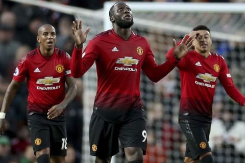 Manchester United's Romelu Lukaku, center, celebrates scoring his side's third goal of the game during their English Premier League soccer match against Fulham at Old Trafford, Manchester, England, Saturday, Dec. 8, 2018. (Barrington Coombs/PA via AP)