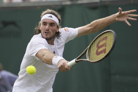 Stefanos Tsitsipas of Greece returns to Serbia's Laslo Djere in a men's singles match on day six of the Wimbledon tennis championships in London, Saturday, July 8, 2023. (AP Photo/Kirsty Wigglesworth)