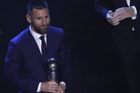 Argentinian Barcelona player Lionel Messi receives the Best FIFA mens player award during the ceremony of the Best FIFA Football Awards, in Milan's La Scala theater, northern Italy, Monday, Sept. 23, 2019. (AP Photo/Antonio Calanni)