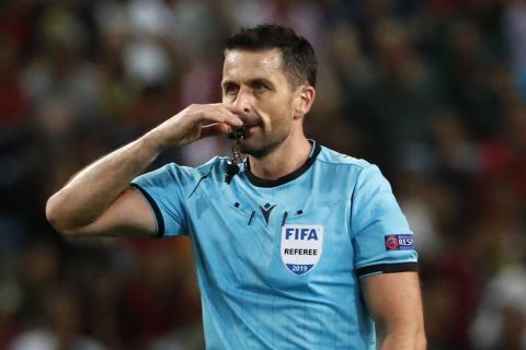Referee Daniel Stefanski blows the whistle during the Euro 2020 group B qualifying soccer match between Portugal and Luxembourg at the Jose Alvalade stadium in Lisbon, Friday, Oct 11, 2019. (AP Photo/Armando Franca)