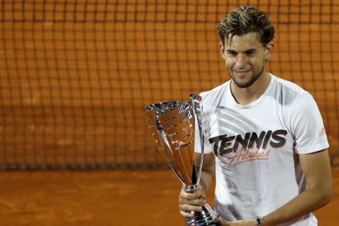 Austria's Dominic Thiem poses with the trophy after winning the final match of the Adria Tour charity tournament against Serbia's Filip Krajinovic, in Belgrade, Serbia, Sunday, June 14, 2020. (AP Photo/Darko Vojinovic)