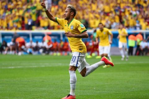 BRASILIA, BRAZIL - JUNE 23:  Neymar of Brazil celebrates after scoring his team's first goal during the 2014 FIFA World Cup Brazil Group A match between Cameroon and Brazil at Estadio Nacional on June 23, 2014 in Brasilia, Brazil.  (Photo by Clive Brunskill/Getty Images)