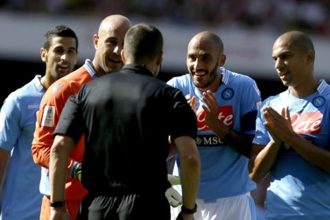 Napoli's Paolo Cannavaro, second right and goalkeeper Pepe Reina, second left talk to referee Kevin Friend after a penalty was awarded to Arsenal, which Reina then saved, during their Emirates Cup soccer game at Arsenal's Emirates stadium in London, Saturday, Aug 3, 2013 . (AP Photo/Alastair Grant)