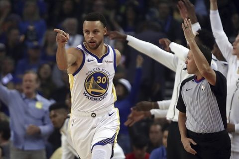Golden State Warriors' Stephen Curry (30) celebrates a score against the Oklahoma City Thunder during the first half of an NBA basketball game, Tuesday, Oct. 16, 2018, in Oakland, Calif. (AP Photo/Ben Margot)
