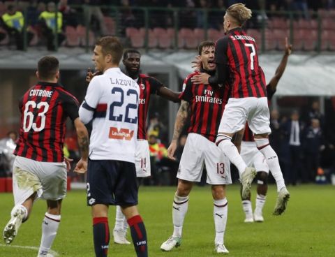 AC Milan's Alessio Romagnoli , 2nd from right, celebrates after scoring his side's second goal during the Serie A soccer match between AC Milan and Genoa at the San Siro Stadium in Milan, Italy, Wednesday, Oct. 31, 2018. AC Milan won 2-0. (AP Photo/Antonio Calanni)