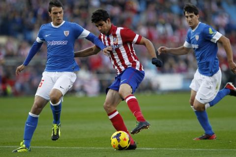 Atletico Madrid's  Diego Costa, centre, runs with the ball between Athletic Bilbao's Erik Moran, left, and Mikel San Jose during the Spanish La Liga soccer match between Atletico Madrid and Athletic Bilbao at the Calderon stadium in Madrid, Sunday, Nov. 3, 2013. Costa scored once in Atletico Madrid's 2-0 victory. (AP Photo/Francisco Seco) 