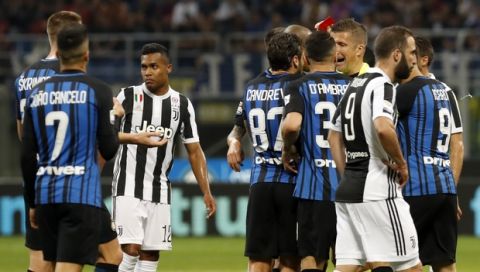 Referee Daniele Orsato shows a red card to Inter Milan's Matias Vecino during the Serie A soccer match between Inter Milan and Juventus at the San Siro stadium in Milan, Italy, Saturday, April 28, 2018. (AP Photo/Antonio Calanni)