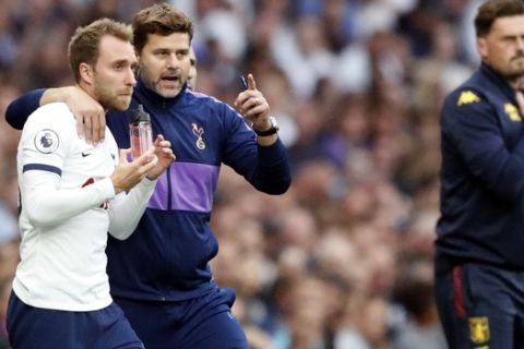 Tottenham's manager Mauricio Pochettino, center, gives instructions to Tottenham's Christian Eriksen during the English Premier League soccer match between Tottenham Hotspur and Aston Villa at the Tottenham Hotspur stadium in London, Saturday, Aug. 10, 2019. (AP Photo/Frank Augstein)