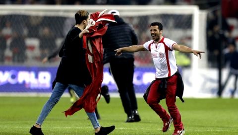 Tunisian supporters invade the pitch after a friendly soccer match between Tunisia and Costa Rica at the Allianz Riviera stadium in Nice, southern France, Tuesday, March 27, 2018. Tunisia won 1-0. (AP Photo/Claude Paris)