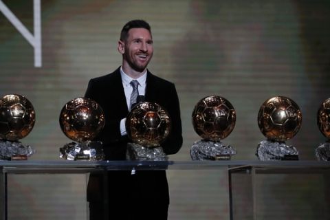 Barcelona's soccer player Lionel Messi poses with his six golden balls during the Golden Ball award ceremony in Paris, Monday, Dec. 2, 2019. (AP Photo/Francois Mori)