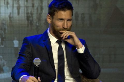 Barcelona's Lionel Messi , reacts to a fan's question on when he will shave his beard during an event to launch the establishment of Messi Experience Park in Beijing, China, Thursday, June 1, 2017. The park to be completed within 2 years in eastern China will be based on football culture and promote the sports amongst China's youths. (AP Photo/Ng Han Guan)