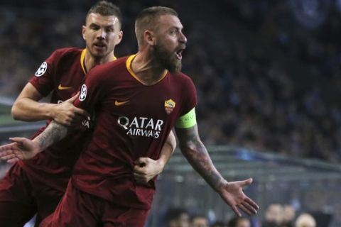 Roma midfielder Daniele De Rossi celebrates with forward Edin Dzeko, background, after scoring his side's first goal during the Champions League round of 16, 2nd leg, soccer match between FC Porto and AS Roma at the Dragao stadium in Porto, Portugal, Wednesday, March 6, 2019. (AP Photo/Luis Vieira)