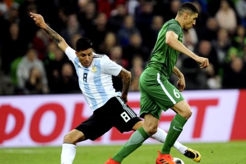 Argentina's Enzo Perez, left, challenges for the ball with Nigeria's William Troost-Ekong during the international friendly soccer match between Argentina and Nigeria in Krasnodar, Russia, Tuesday, Nov. 14, 2017. (AP Photo/Sergey Pivovarov)
