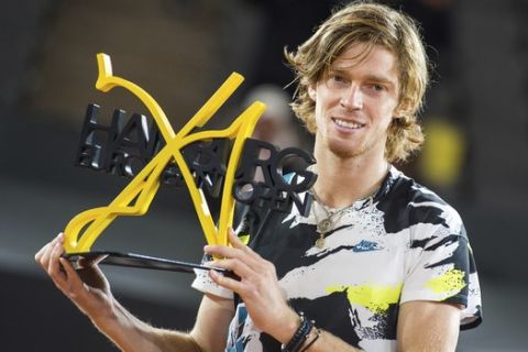 Andrey Rublev of Russia holds the trophy after his victory against Stefanos Tsitsipas of Greece at the ATP Tour -  European Open in Hamburg, Germany, Sunday, Sept. 27, 2020. The 22-year-old defeated the number two seeded Greek 6-4, 3-6, 7-5 in the final. (Daniel Bockwoldt/dpa via AP)