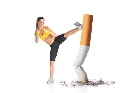 Girl kicking a cigarette butt isolated against white background