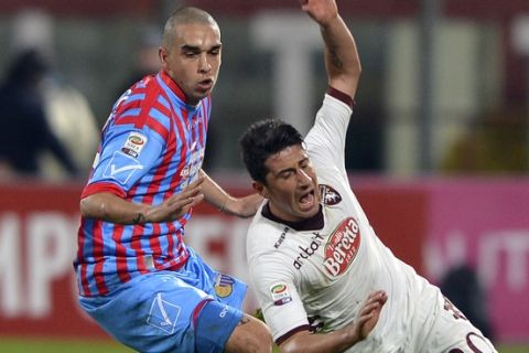 Catania defender Giuseppe Bellusci, left, vies for the ball with Torino midfielder Giuseppe Vives during a Serie A soccer match at the Angelo Massimino stadium in Catania, Italy, Saturday, Jan. 5, 2013. (AP Photo/Carmelo Imbesi)
