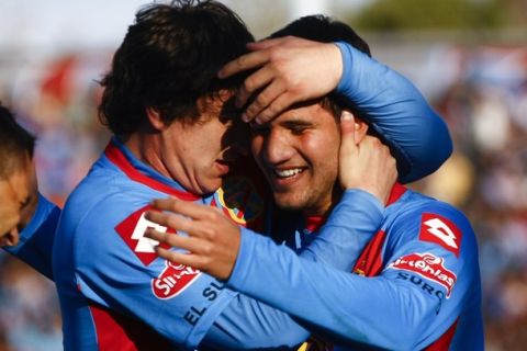 Lisandro Lopez of Arsenal, right, celebrates with teammate Nicolas Aguirre after scoring against Belgrano during an Argentina's league soccer match in Buenos Aires, Argentina, Sunday, June 24, 2012. (AP Photo/Eduardo Di Baia)