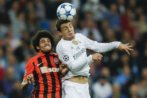 Real Madrid's Mateo Kovacic heads the ball flanked by Shakhtar's Marcio Azevedo during a Group A Champions League soccer match between Real Madrid and Shakhtar Donetsk at the Santiago Bernabeu stadium in Madrid, Spain, Tuesday, Sept. 15, 2015. (AP Photo/Paul White)
