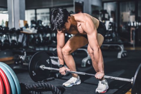 Gym fitness weightlifting deadlift Asian man bodybuilding powerlifting indoor sport club. Bodybuilder doing barbell weight lifting training workout with heavy bar.