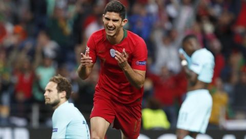 Portugal's Goncalo Guedes, centre, reacts after scoring his team's first goal during the UEFA Nations League final soccer match between Portugal and Netherlands at the Dragao stadium in Porto, Portugal, Sunday, June 9, 2019. (AP Photo/Armando Franca)