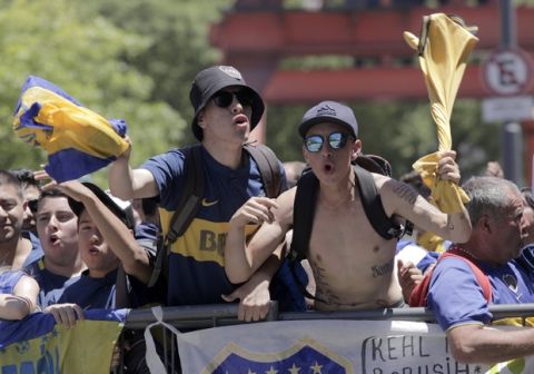 Boca Juniors soccer fans gather outside the hotel where their team is staying in Buenos Aires, Argentina, Sunday, Nov. 25, 2018. In one of the most embarrassing weekends in South American football history, the Copa Libertadores final between arch rivals Boca Juniors and River Plate was once more postponed on Sunday. The same decision was made on Saturday after Boca's bus was attacked by River fans. (AP Photo/Ana Mombello)