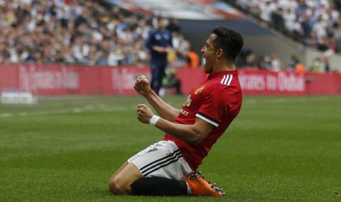Manchester United's Alexis Sanchez celebrates after scoring his sides 1st goal during the English FA Cup semifinal soccer match between Manchester United and Tottenham Hotspur at Wembley stadium in London, Saturday, April 21, 2018. (AP Photo/Frank Augstein)