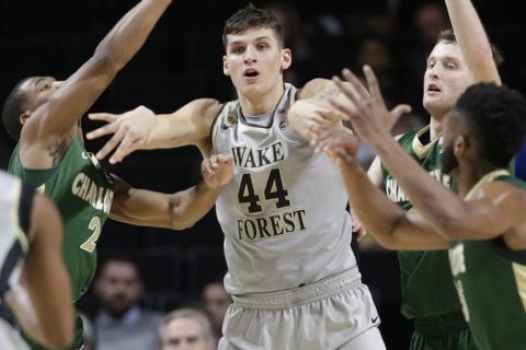 Wake Forest's Konstantinos Mitoglou (44) pass the ball as he is trapped by Charlotte players during the second half of an NCAA college basketball game in Winston-Salem, N.C., Tuesday, Dec. 6, 2016. Wake Forest won 91-74. (AP Photo/Chuck Burton)