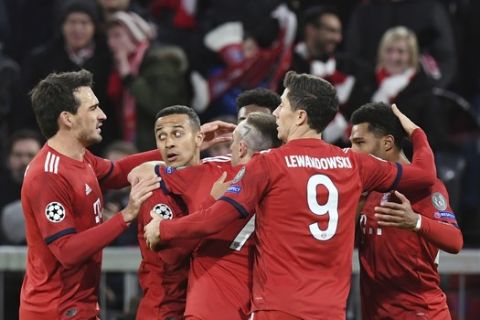 Bayern players celebrate after Liverpool defender Joel Matip scores an own goal during the Champions League round of 16 second leg soccer match between Bayern Munich and Liverpool at the Allianz Arena, in Munich, Germany, Wednesday, March 13, 2019. (AP Photo/Kerstin Joensson)