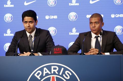 French soccer player Kylian Mbappe, right, and chairman of Paris Saint-Germain Nasser Al-Khelaifi attend a press conference in Paris, Wednesday, Sept. 6, 2017. Mbappe is a young man in a big hurry and wants to "win everything" with his new club Paris Saint-Germain. (AP Photo/Christophe Ena)