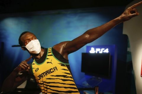 In order to raise awareness against the spread of the coronavirus, a mask is placed on the wax figure of Jamaica's Usain Bolt at Madame Tussauds attraction in Istanbul, Saturday, July 11, 2020. Turkish authorities have made the wearing of masks mandatory in most of the country to curb the spread of COVID-19 following an uptick in confirmed cases since the reopening of many businesses. (AP Photo/Emrah Gurel)